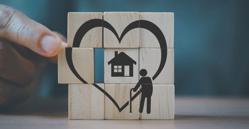 A picture of a blocks forming a love sign with a house to show love for the home. 
