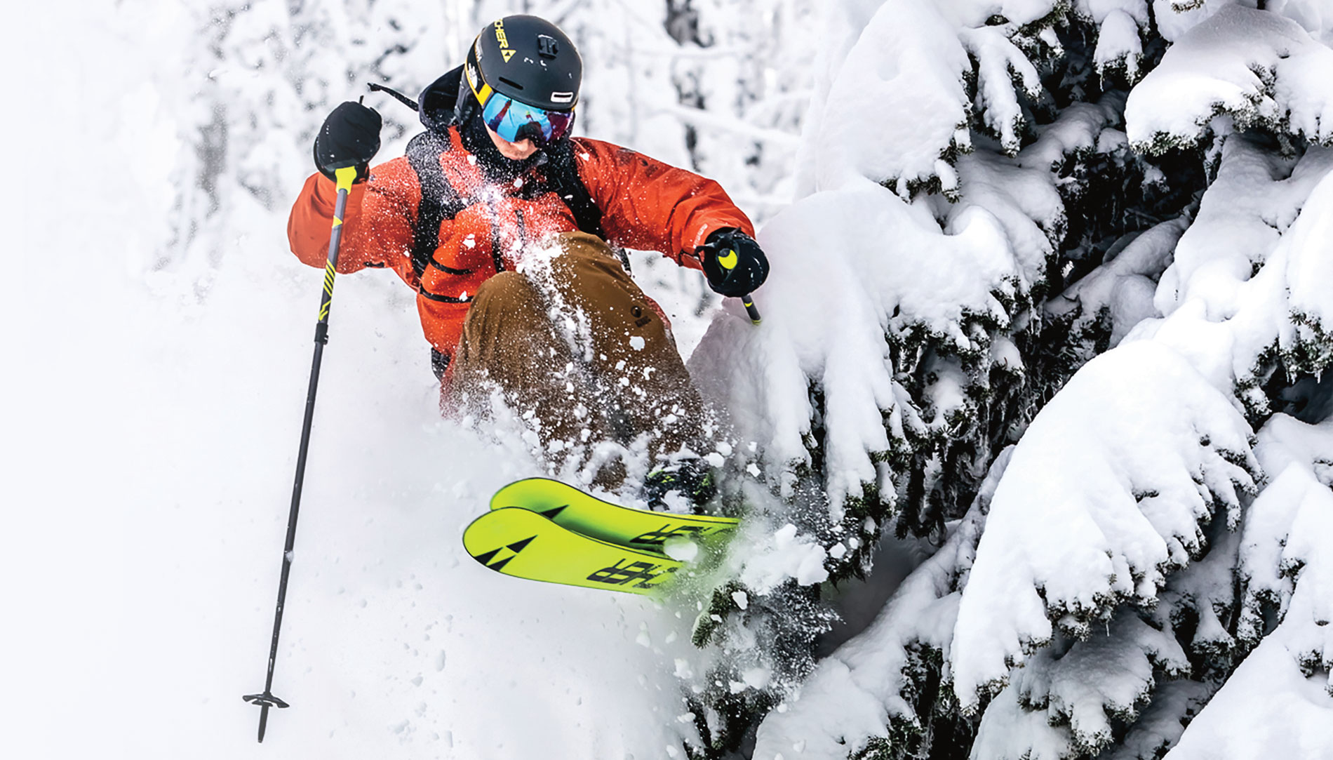 A skier lauching off a tree at Whitewater Ski Resort