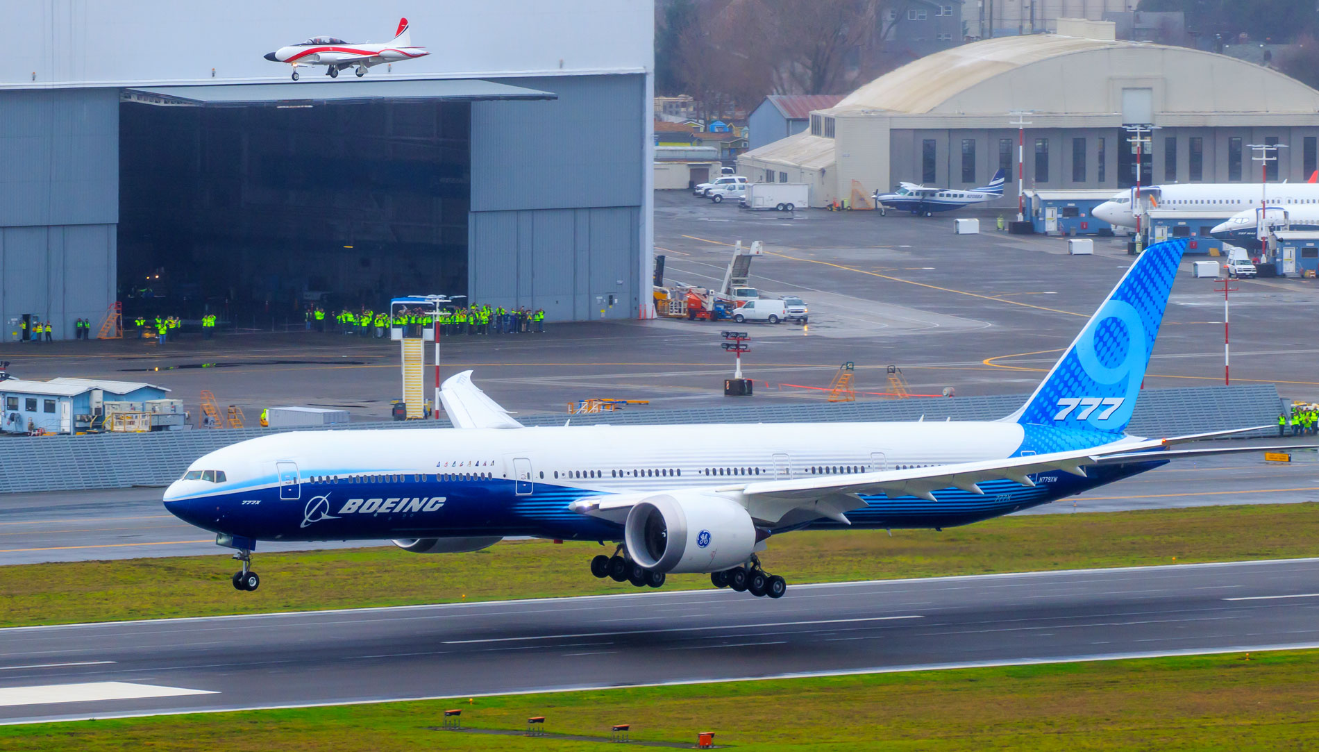 Boeing’s 777X lands at Boeing field in January 2020 to conclude its first flight and a loop around Mount Rainier, accompanied by a Boeing T-33 chase plane.