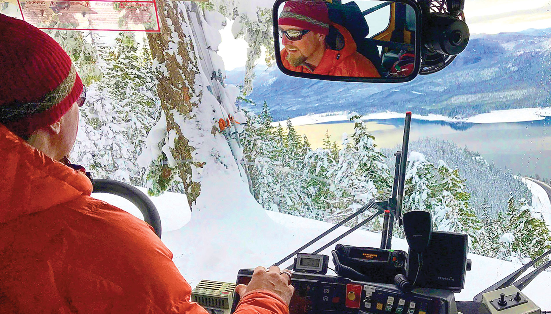 Avalanche control expert John Stimberis drives a snowcat in the mountains above Interstate 90 through the Cascade Mountains