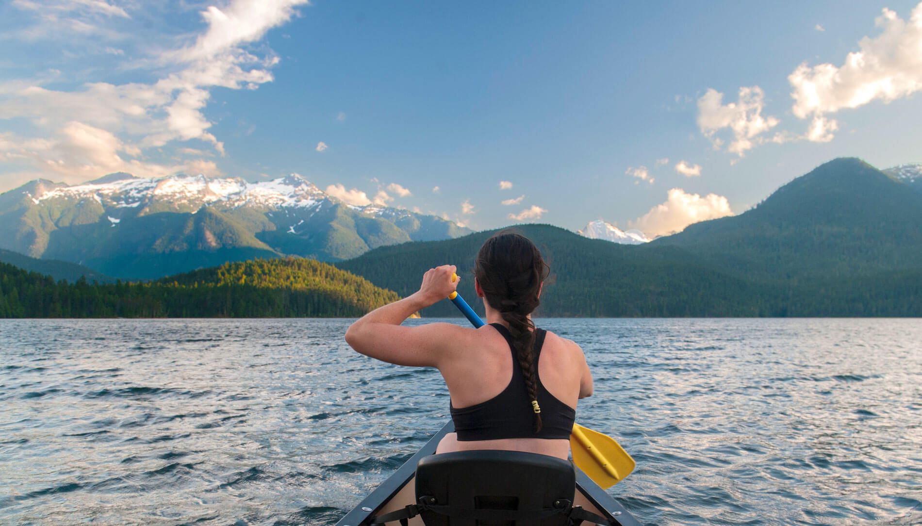 A woman canoes on Ross Lake in Washington