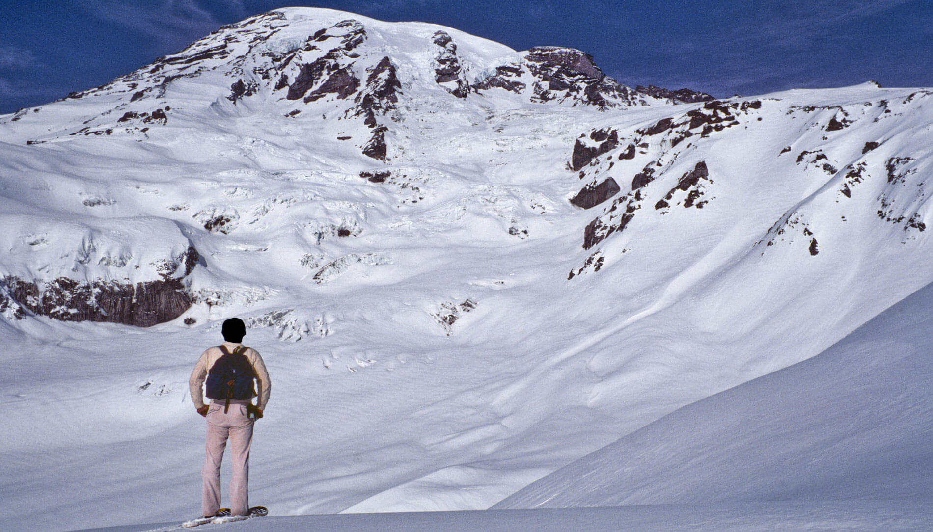 A person looking at snow near Mount Rainier