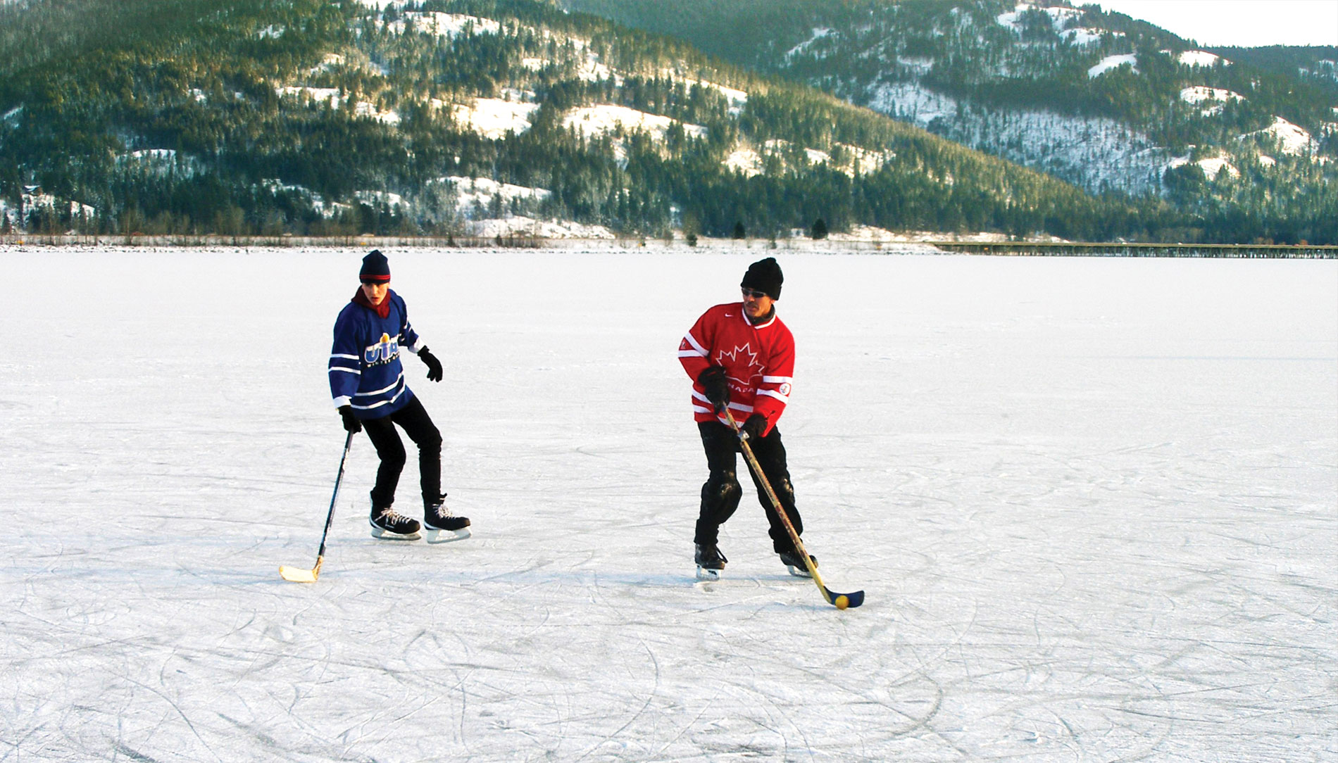 Ice skaters play hockey on frozen waters in Northern Idaho