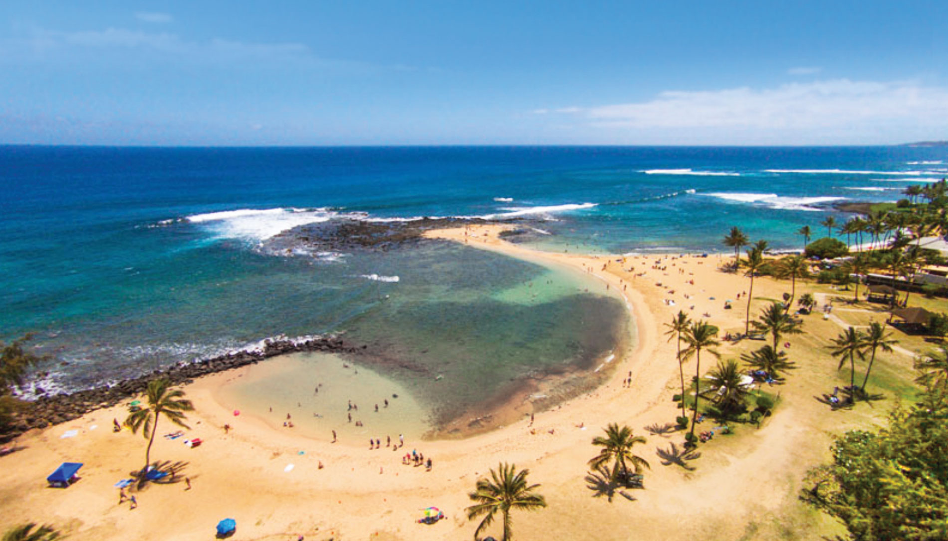 Hawaii's Poipu Beach is shaped like a whale, with a sandy tail extending into the water