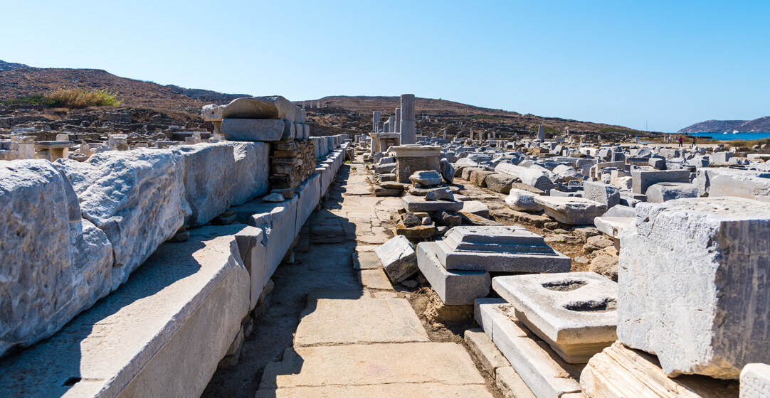 Greek Travel The Sacred Way ancient ruins Archaeological Site of Delos island Cyclades Greece Stavrarg AdobeStock