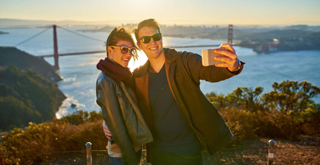 Taking a selfie in front of the Golden Gate Bridge in San Francisco is a must for couples. 