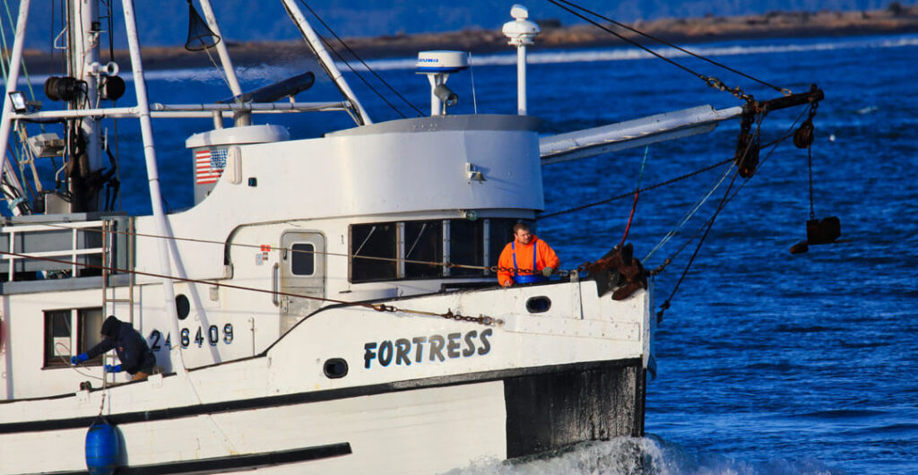 Deckhands on the FV Fortress prepping the boat to dock in Westport. Photo: Lost River Photography