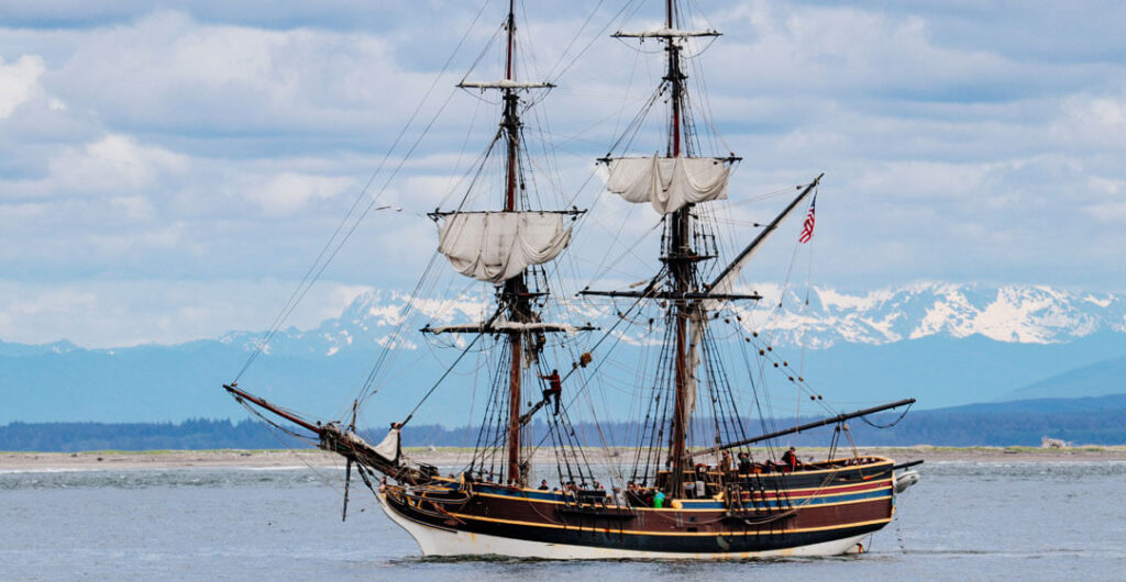 The Lady Washington sailing past Damon Point and the Olympic Mountains. Photo: Lost River Photography
