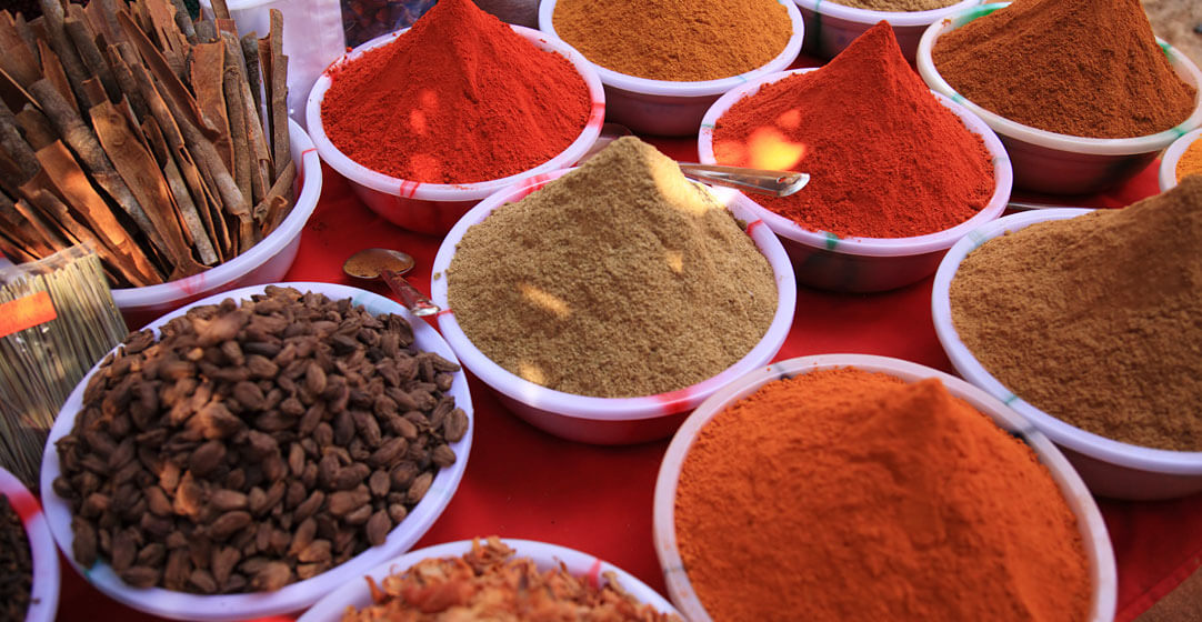 foodie cooking spices in Indian market by deborah benbrook adobe stock