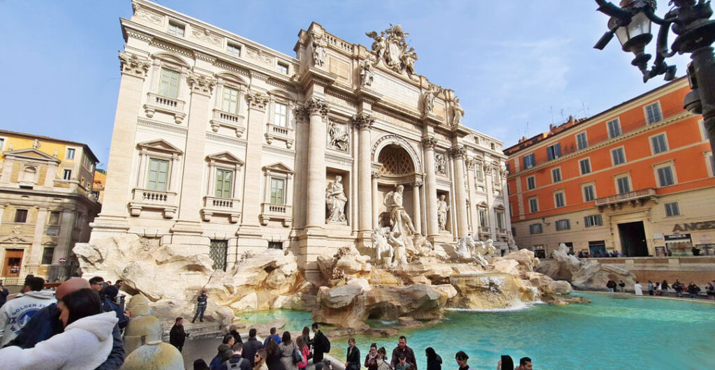 A crowd gathers around the Trevi Fountain in Rome in the off-season.
