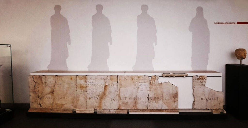 The shadow of several roman statues reflect off the wall at the museo nazionale romano near the train terminal in Rome. 