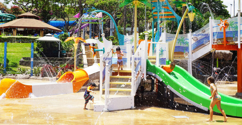 Kids playing on a water slide at Wet N Wild in Hawaii