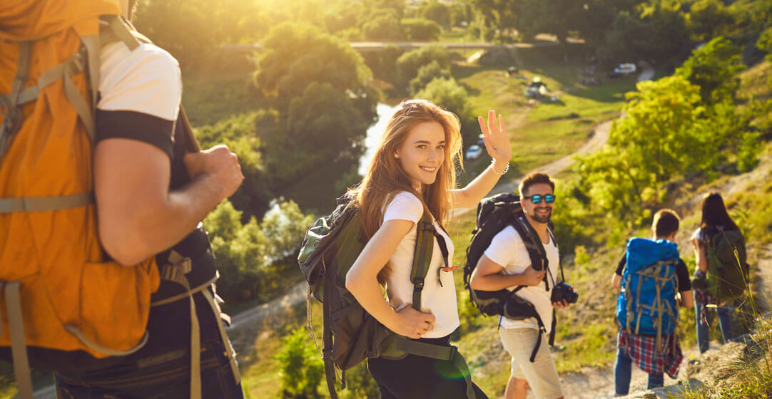 Stay healthy while traveling with these travel tips. Hikers on a beautiful trail.