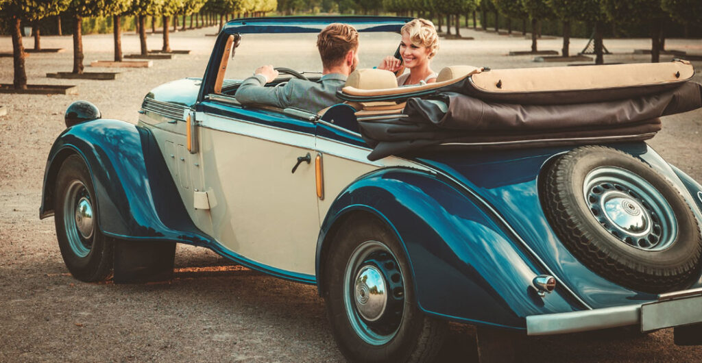 classic cars couple in classic convertible By Nejron Photo AdobeStock