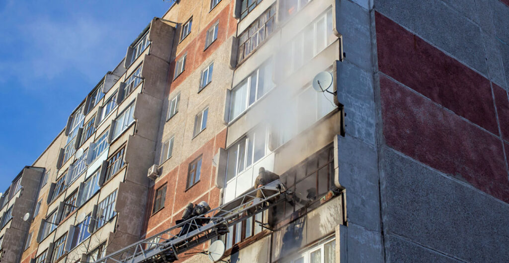 A fire breaks out on the outside of a condo, to illustrate the need for condo insurance. 