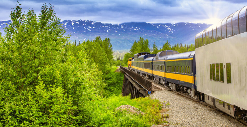 AAA Travel curates several tours in North America that feature rail travel. Pictured here, the train is heading up to Denali National Park in Alaska.